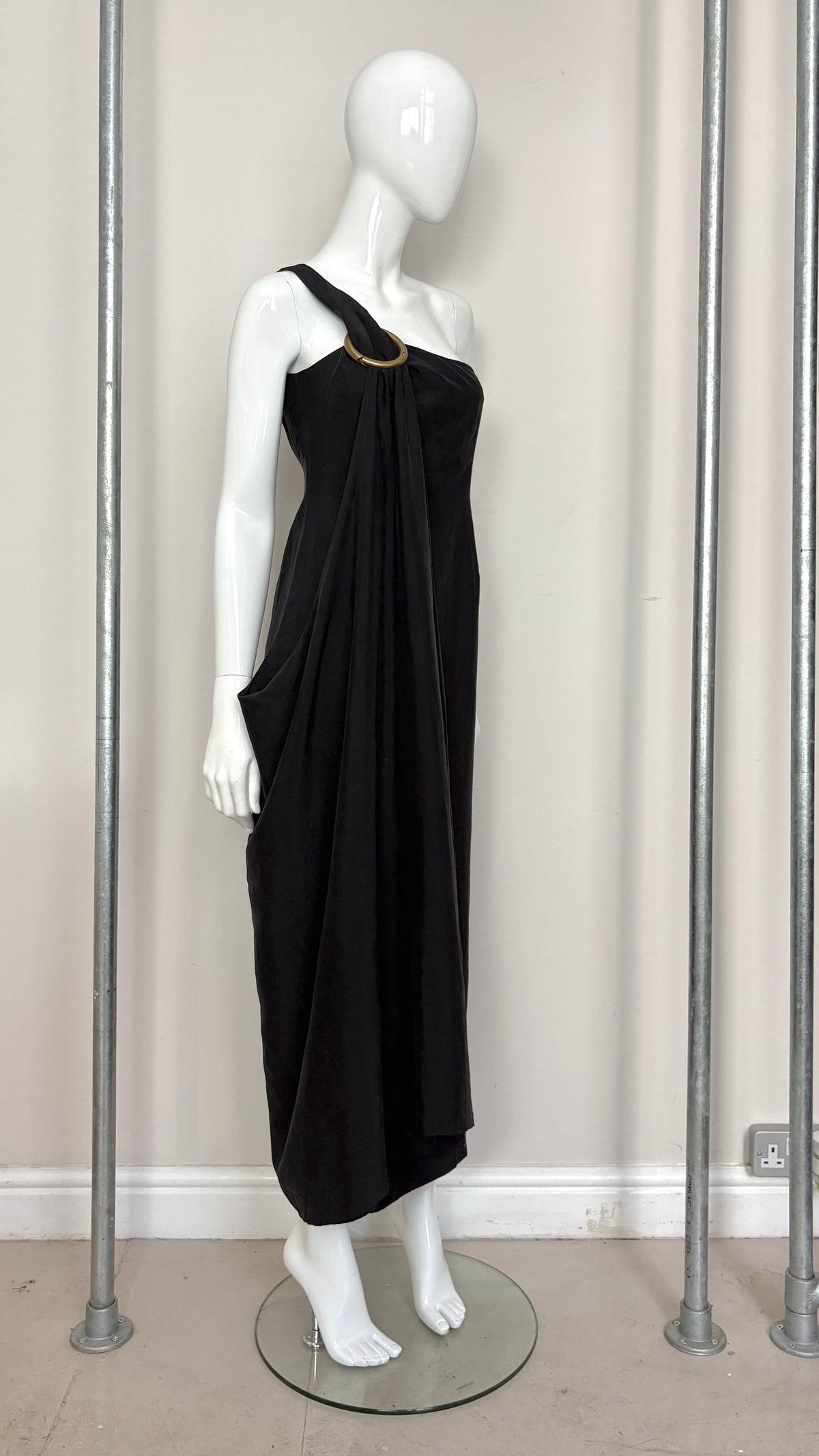 Sybilla draped black gown with gold ring hardware