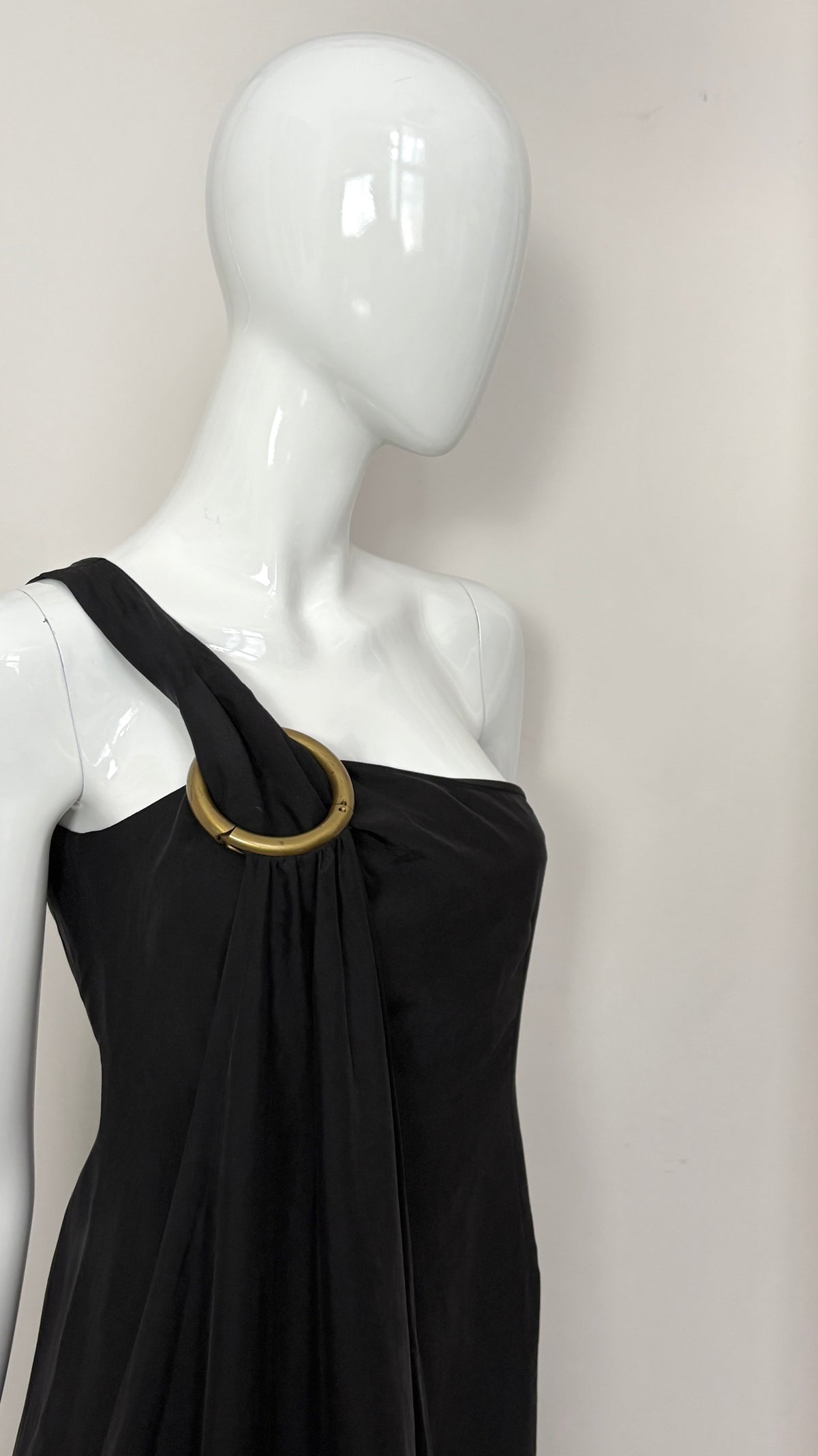 Sybilla draped black gown with gold ring hardware