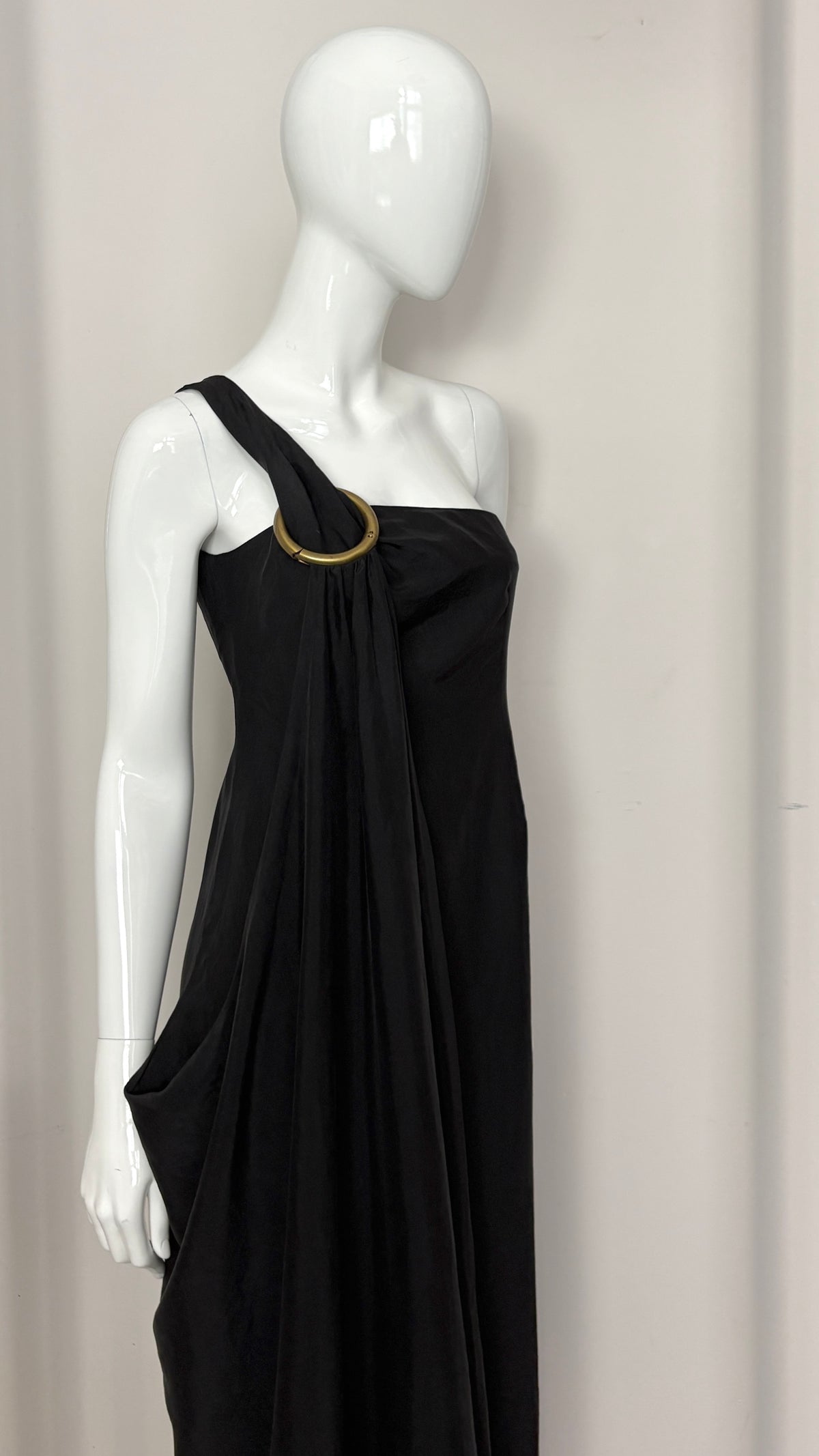 Sybilla draped black gown with gold ring hardware