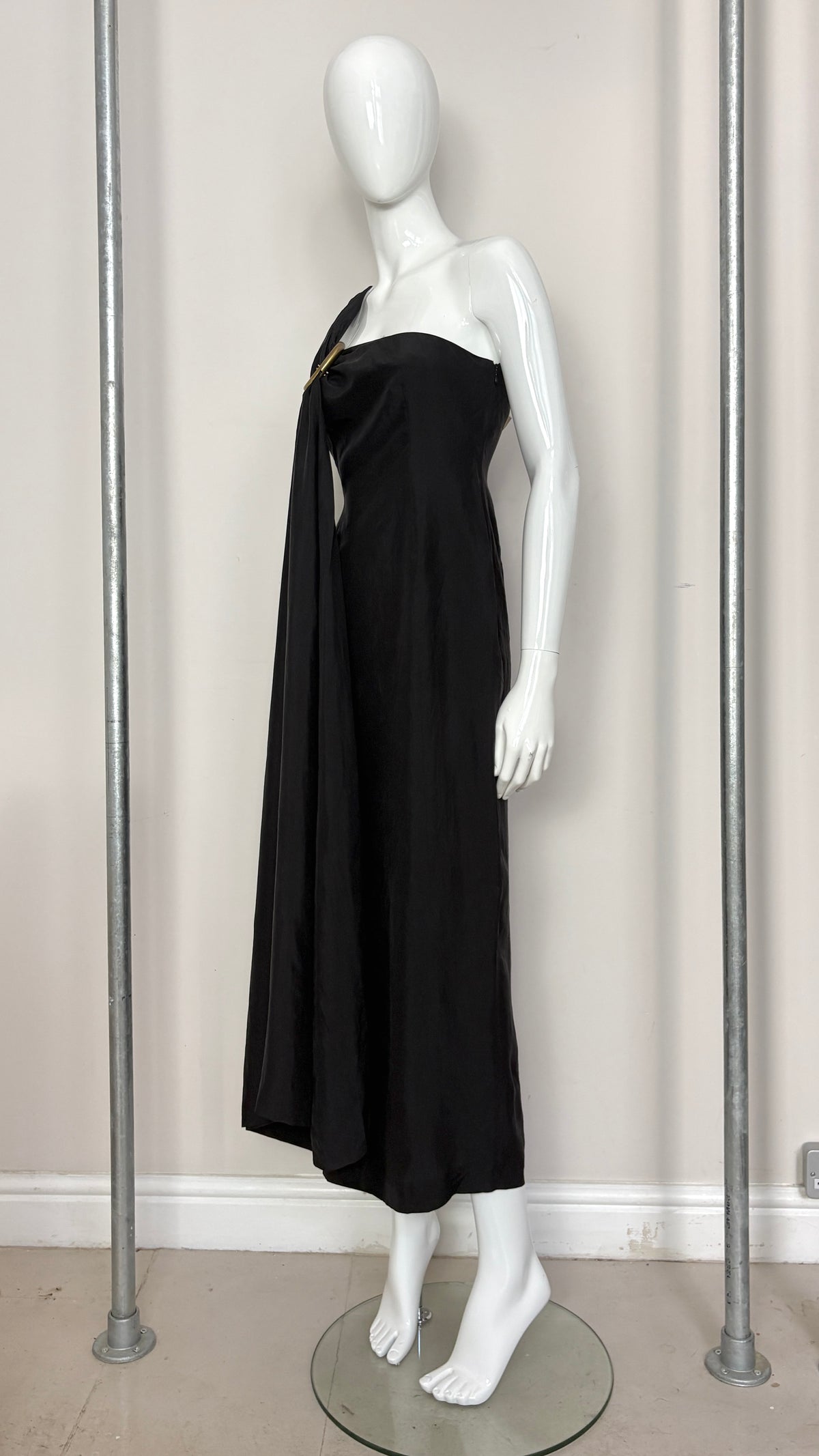 Sybilla draped black gown with gold ring hardware