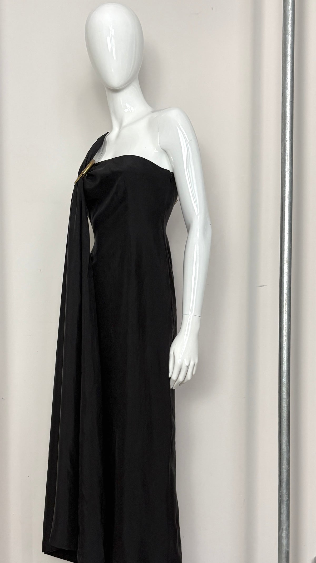 Sybilla draped black gown with gold ring hardware