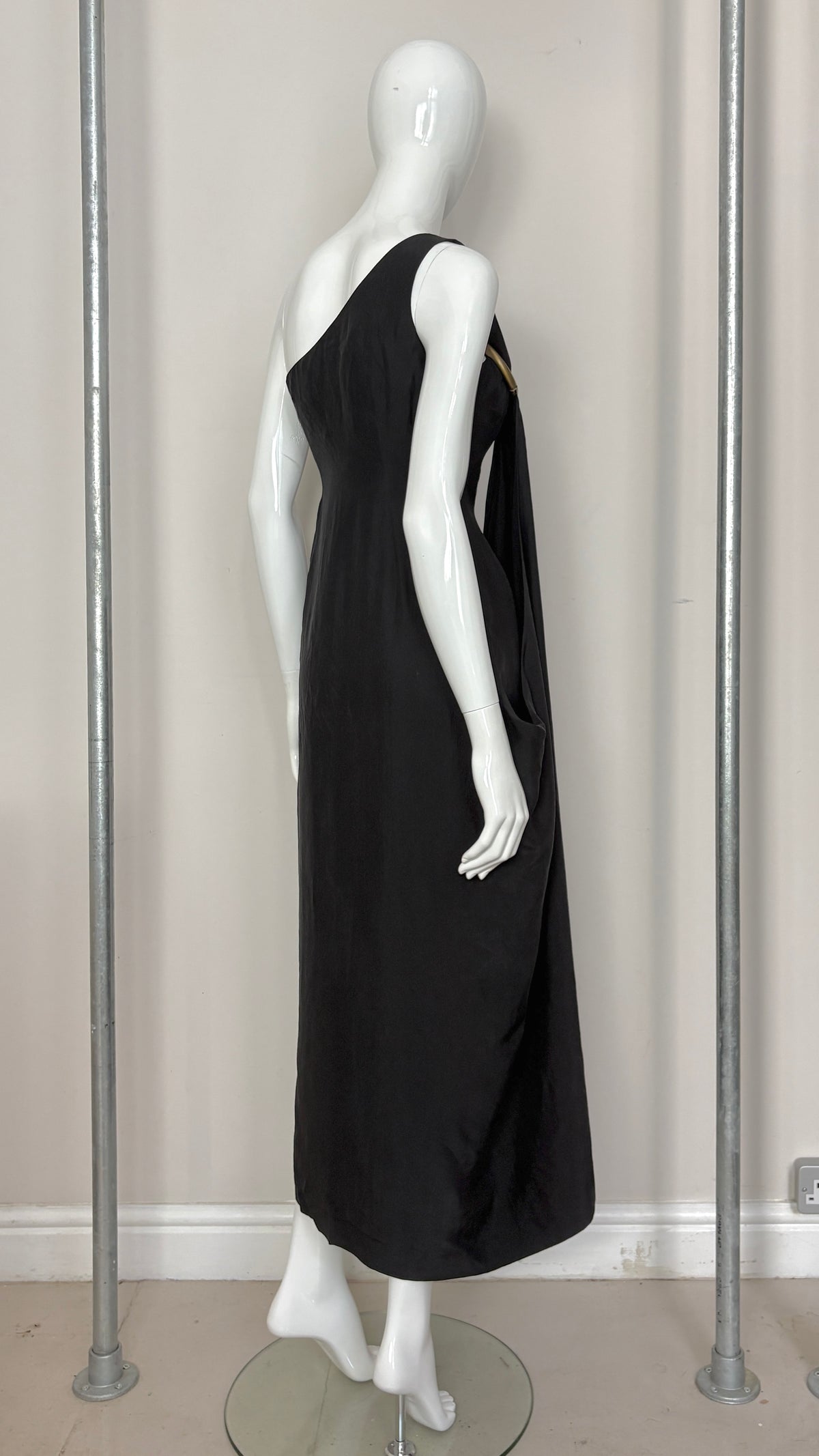 Sybilla draped black gown with gold ring hardware