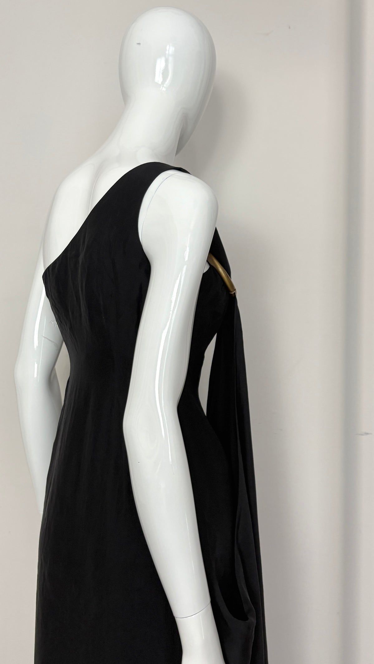 Sybilla draped black gown with gold ring hardware